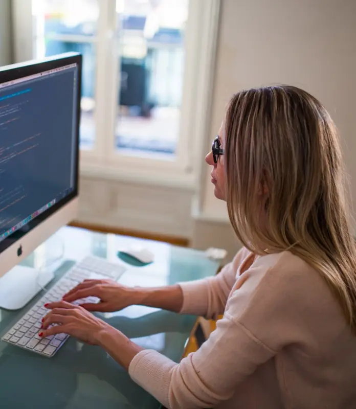 An operations lead working at a desktop computer