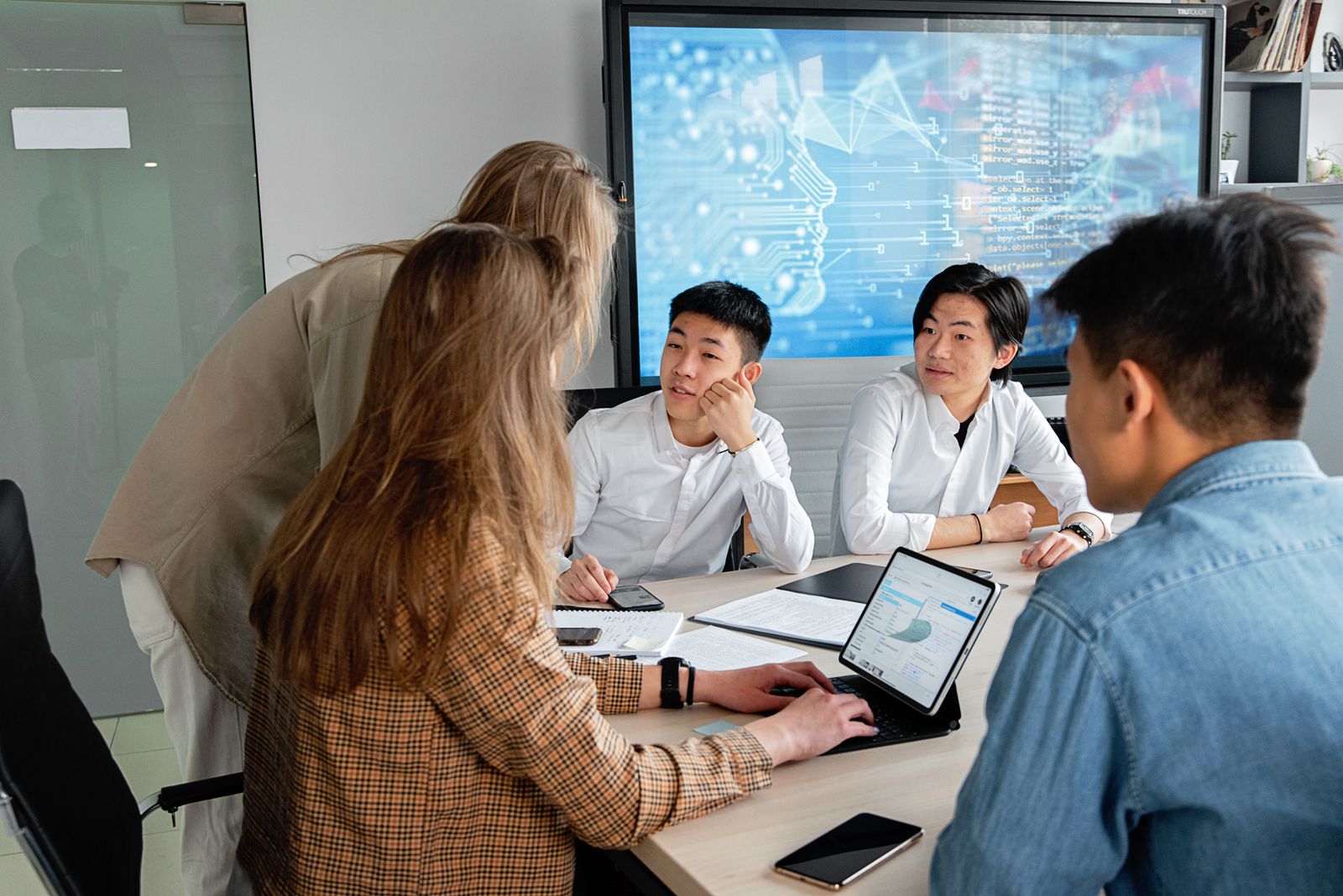Product team collaborating around a digital interface