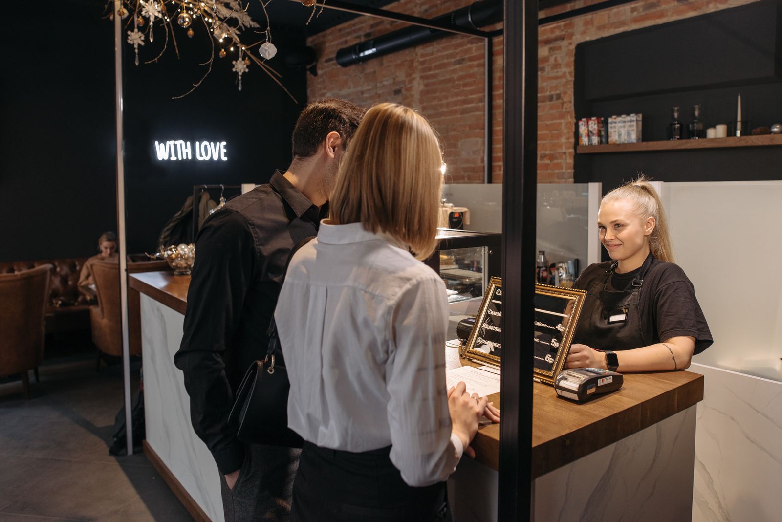 Cafe owner serving customers at a counter